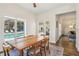 The dining room features hardwood floors, a modern table set and views of the pool at 356 N Spaulding Cv, Lake Mary, FL 32746
