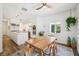 Dining room with hardwood floors, modern chandelier, and a view of the bright kitchen at 356 N Spaulding Cv, Lake Mary, FL 32746