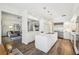 Bright, open kitchen features stainless steel appliances, center island, and pendant lighting overlooking the living space at 356 N Spaulding Cv, Lake Mary, FL 32746