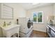 Bright laundry room includes sink, counter space, window view, and a modern washer/dryer set at 356 N Spaulding Cv, Lake Mary, FL 32746