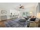 Open-concept living room with hardwood floors, a modern sofa, and access to the patio area at 356 N Spaulding Cv, Lake Mary, FL 32746