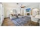 Stylish living room featuring hardwood floors, exposed brick, and comfortable seating with ample light at 356 N Spaulding Cv, Lake Mary, FL 32746