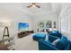 Bright living room featuring tray ceiling, entertainment center, and access to outdoor pool area at 356 N Spaulding Cv, Lake Mary, FL 32746