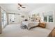 Spacious main bedroom features a ceiling fan, and barn door to the ensuite at 356 N Spaulding Cv, Lake Mary, FL 32746