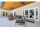 Covered patio with outdoor furniture, ceiling fans, and access to a screened-in pool area at 356 N Spaulding Cv, Lake Mary, FL 32746