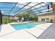 Screened-in pool and patio area with lush landscaping, seating, and a built-in hot tub at 356 N Spaulding Cv, Lake Mary, FL 32746