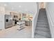 Modern kitchen featuring stainless steel appliances, center island and easy access to stairs at 3610 Raindrop Way, Sanford, FL 32773