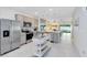 Bright kitchen features stainless steel appliances, gray cabinetry, and opens to living area at 3610 Raindrop Way, Sanford, FL 32773