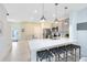 Modern kitchen with stainless steel appliances, white countertops, and stylish island seating at 3610 Raindrop Way, Sanford, FL 32773