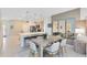 Modern kitchen connected to the dining area, featuring stainless appliances and island seating at 3610 Raindrop Way, Sanford, FL 32773