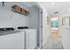 Convenient laundry room includes a washer, dryer, storage shelf, and offers easy access to other areas at 3610 Raindrop Way, Sanford, FL 32773