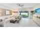 Inviting living room with stylish decor, including a comfortable sofa, decorative wall art and sliding glass doors at 3610 Raindrop Way, Sanford, FL 32773