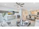 Spacious living and dining area with modern decor, opening to a well-equipped kitchen at 3610 Raindrop Way, Sanford, FL 32773