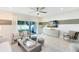 Bright living room featuring neutral tones, a modern ceiling fan, and sliding glass doors to the outdoor space at 3610 Raindrop Way, Sanford, FL 32773