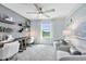 Bright office featuring two built-in desks, shelving, stylish chairs, and a comfortable seating area at 3610 Raindrop Way, Sanford, FL 32773