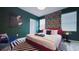Inviting bedroom with modern art, bold wallpaper, and a comfortable red platform bed for restful nights at 3880 Sonoma Blvd, Kissimmee, FL 34741