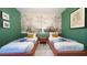 Stylish bedroom featuring two twin beds, decorative wall art, and soft lighting at 3880 Sonoma Blvd, Kissimmee, FL 34741