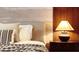 Serene bedroom showcasing a well-lit nightstand and a plush, inviting bed setup at 3880 Sonoma Blvd, Kissimmee, FL 34741