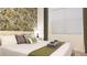 Bright bedroom featuring a comfortable bed, floral wallpaper, and well lit from window at 3880 Sonoma Blvd, Kissimmee, FL 34741