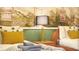 Cozy twin beds with mustard pillows feature a lamp and botanical art at 3880 Sonoma Blvd, Kissimmee, FL 34741