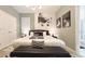 Elegant bedroom with queen bed, black bench, and modern art at 3880 Sonoma Blvd, Kissimmee, FL 34741