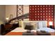 Comfortable bedroom featuring a vibrant accent wall and scenic artwork at 3880 Sonoma Blvd, Kissimmee, FL 34741