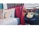 Inviting bedroom with a stylish pink headboard, modern art, and comfortable linens at 3880 Sonoma Blvd, Kissimmee, FL 34741