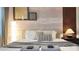 Neutral-toned bedroom with unique lighting, textured walls, and a comfortable, inviting bed at 3880 Sonoma Blvd, Kissimmee, FL 34741