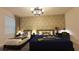 Tastefully decorated bedroom with two beds, patterned wallpaper, dark furniture, and a ceiling fan at 3880 Sonoma Blvd, Kissimmee, FL 34741