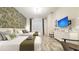 Charming bedroom with twin beds, floral wallpaper, and a modern entertainment center with a TV at 3880 Sonoma Blvd, Kissimmee, FL 34741