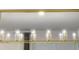 Close up of modern dining room chandelier with glass encased elements and gold framework at 3880 Sonoma Blvd, Kissimmee, FL 34741