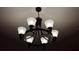 Close-up of a dark chandelier with clear glass shades, providing ambient lighting to the room at 3880 Sonoma Blvd, Kissimmee, FL 34741