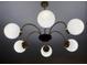 Retro-style chandelier featuring multiple white glass globe lights and brass-tone arms at 3880 Sonoma Blvd, Kissimmee, FL 34741