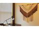Wall with Macrame art near a window with a work desk in a neutral colored room at 3880 Sonoma Blvd, Kissimmee, FL 34741