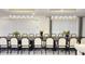 Elegant dining room with a long table, stylish chairs, and modern lighting at 3880 Sonoma Blvd, Kissimmee, FL 34741