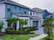 A row of modern homes showcases manicured lawns, palm trees, and contemporary gray and teal exterior color schemes at 3880 Sonoma Blvd, Kissimmee, FL 34741