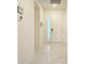 A bright hallway features sleek tile floors, white walls, and a modern front door with glass panels at 3880 Sonoma Blvd, Kissimmee, FL 34741
