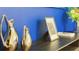 Tastefully decorated shelf with vases, artwork, and a second floor plan, adding character to the home at 3880 Sonoma Blvd, Kissimmee, FL 34741