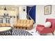 Stylish living room with unique couch, modern rug, and stairs to the next floor at 3880 Sonoma Blvd, Kissimmee, FL 34741