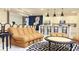 Spacious living room with a modern couch, breakfast bar and adjacent dining area with elegant chandelier at 3880 Sonoma Blvd, Kissimmee, FL 34741