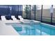Screened-in pool and hot tub area with lounge chairs and a view of the backyard at 3880 Sonoma Blvd, Kissimmee, FL 34741