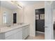 Well-lit bathroom with double sinks, white cabinets, and modern fixtures for a clean and updated look at 405 Meadowland Pt, Oviedo, FL 32765