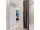 A view from the bathroom leading to a bedroom with a large shower behind a gray curtain at 405 Meadowland Pt, Oviedo, FL 32765