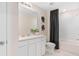 Modern bathroom featuring a shower and bathtub combo with a white vanity and neutral color palette at 405 Meadowland Pt, Oviedo, FL 32765