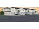 New townhome building showing multiple units with attached garages and landscaping at 405 Meadowland Pt, Oviedo, FL 32765