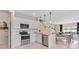 Modern kitchen featuring stainless appliances and an adjacent dining area for open-concept living at 405 Meadowland Pt, Oviedo, FL 32765