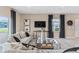 Inviting living room with large windows, a modern media console, and contemporary decor for style at 405 Meadowland Pt, Oviedo, FL 32765