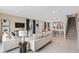 Spacious living area leading into an open-concept kitchen and dining room with easy access to stairs at 405 Meadowland Pt, Oviedo, FL 32765