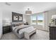 Serene bedroom features soft carpeting, a decorative wall, and large windows that let in natural light at 405 Meadowland Pt, Oviedo, FL 32765