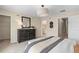 Calm bedroom featuring dark wood furniture, carpet, and an ensuite bathroom with a walk-in closet at 405 Meadowland Pt, Oviedo, FL 32765